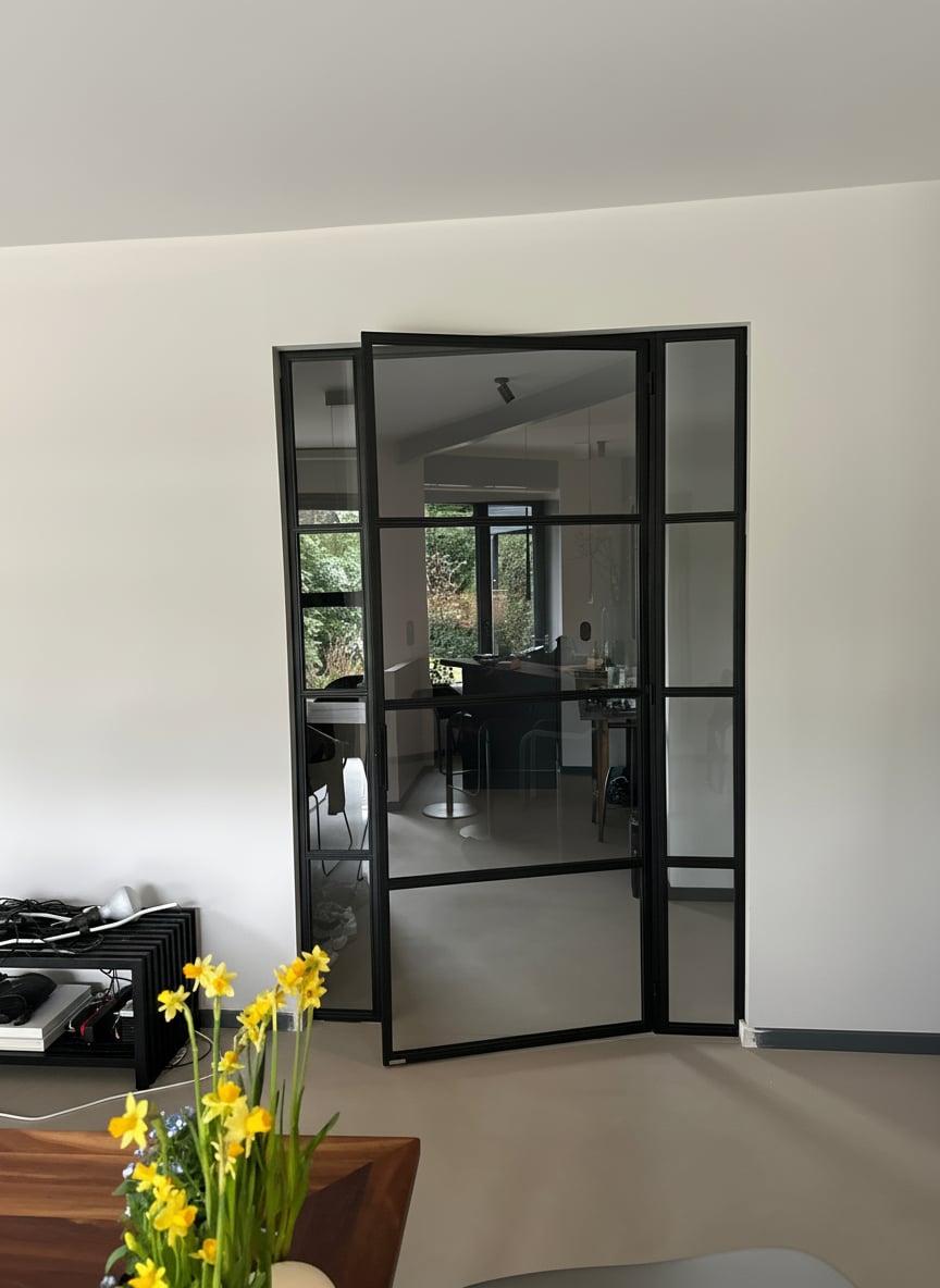 Stahl-Glas-Drehtür mit zwei Seitenteilen und Oberlicht im Wohnbereich